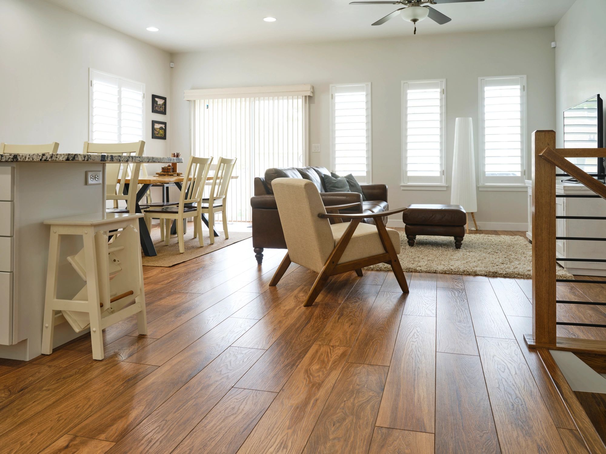 Open concept living room featuring warm wood laminate flooring.